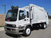 2004 GMC T7500 with McNeilus 17 Yard Rear Loader Refuse Truck